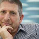 A man with his chin resting on his hand.