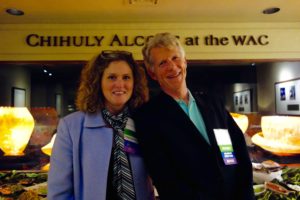 A Photograph of a Man and a Woman in Front of a Banner